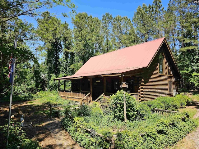 exterior space with covered porch and log siding
