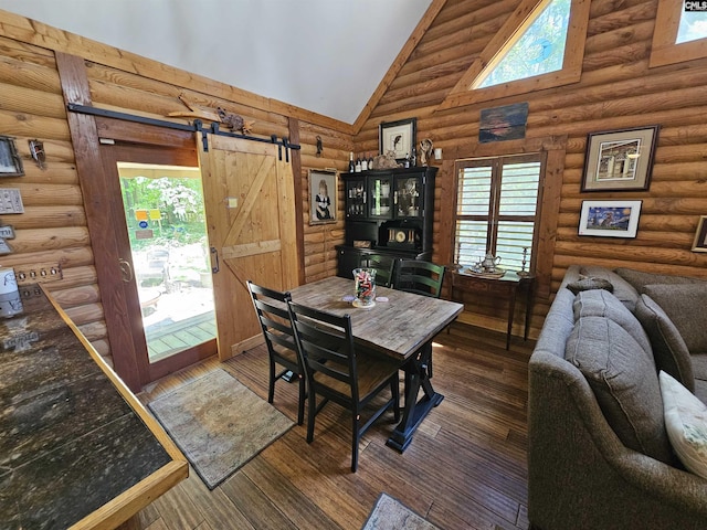 dining area featuring wood-type flooring, a barn door, log walls, and high vaulted ceiling