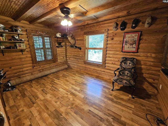 interior space featuring wooden ceiling, beamed ceiling, a ceiling fan, and hardwood / wood-style floors