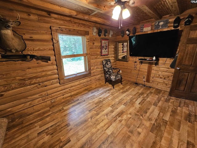 living area with wooden ceiling, ceiling fan, beamed ceiling, and light wood-style flooring