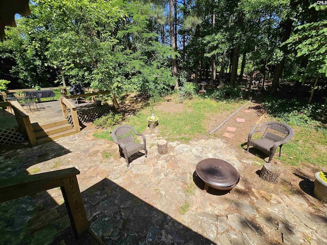view of yard featuring a wooden deck and an outdoor fire pit