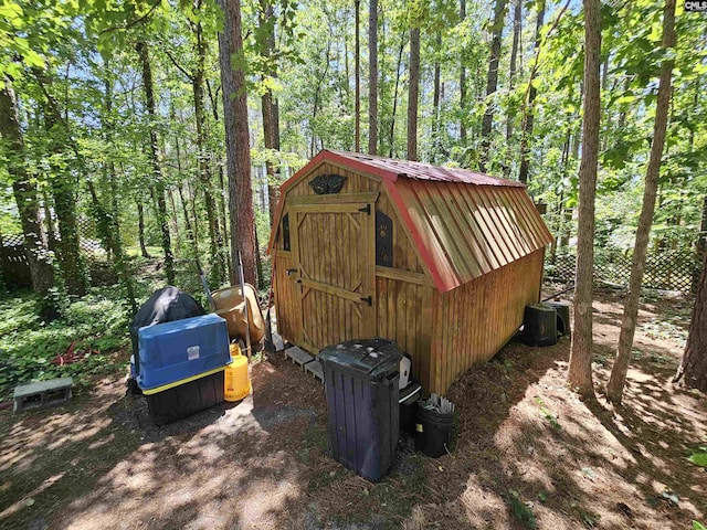 view of shed with a wooded view