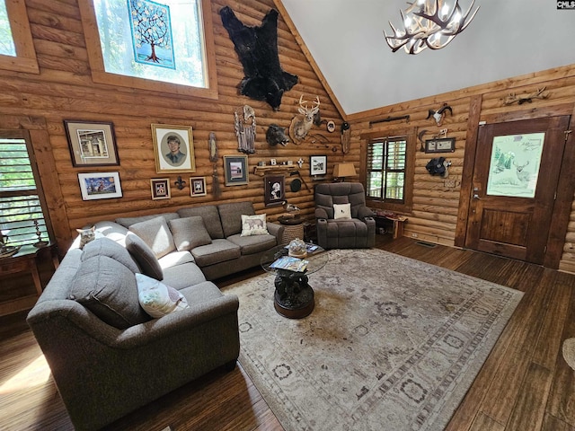 living room featuring high vaulted ceiling, a notable chandelier, log walls, and hardwood / wood-style flooring