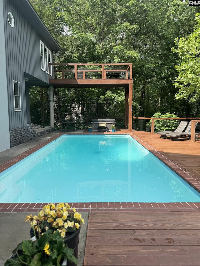 outdoor pool with a wooden deck