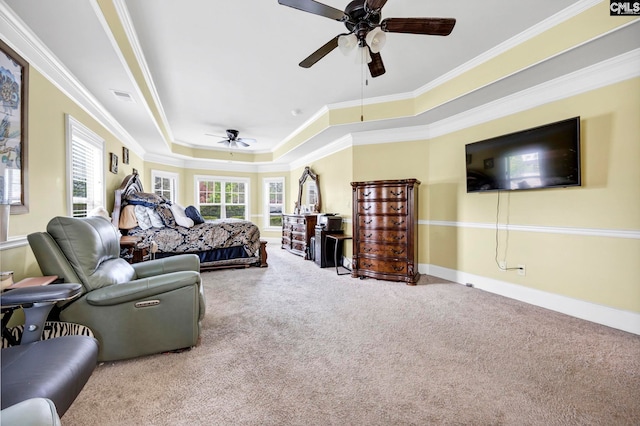 carpeted bedroom featuring crown molding, a raised ceiling, baseboards, and visible vents