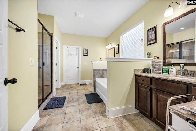 full bathroom with vanity, baseboards, a stall shower, and a bath