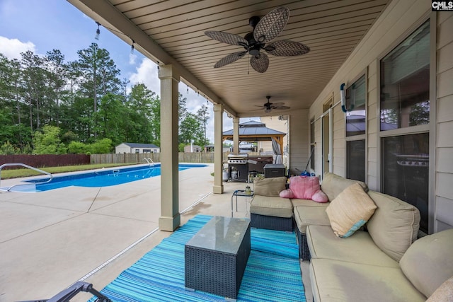 view of patio with outdoor lounge area, a fenced backyard, a fenced in pool, a ceiling fan, and a gazebo