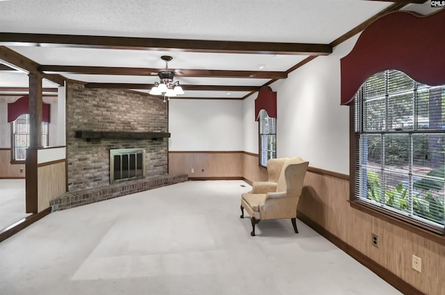 unfurnished room featuring plenty of natural light, a wainscoted wall, and wooden walls