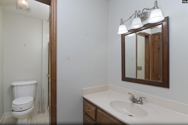 bathroom featuring visible vents, tile patterned floors, toilet, and vanity