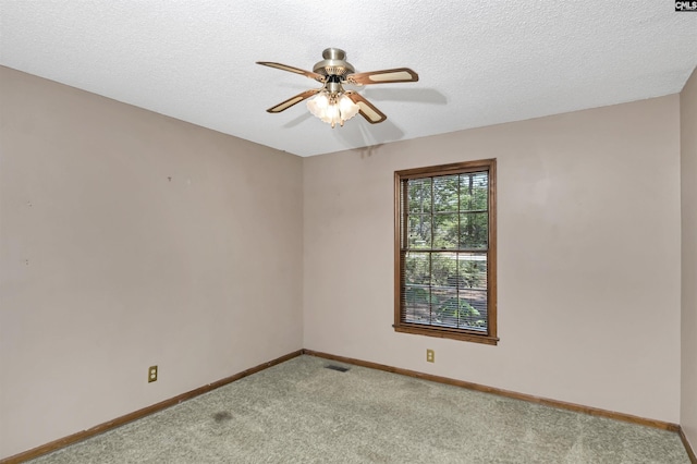 empty room featuring light colored carpet, baseboards, and ceiling fan