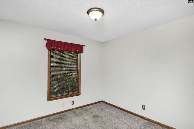 carpeted spare room with baseboards