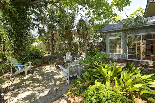 exterior space with fence and a fire pit