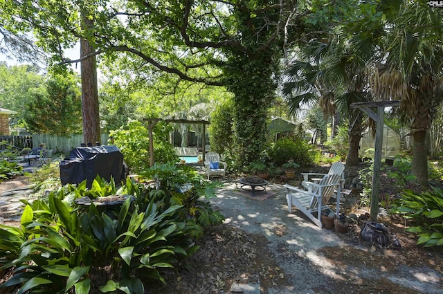 view of patio featuring fence and a fire pit
