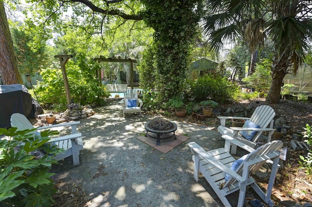 view of patio / terrace featuring an outdoor fire pit