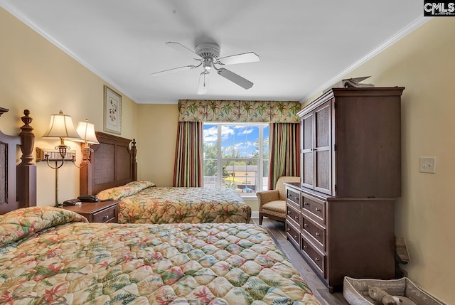 bedroom featuring baseboards, ornamental molding, ceiling fan, and wood finished floors