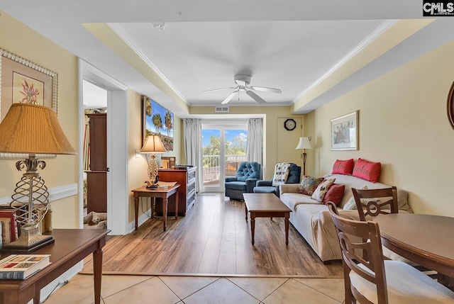 living area featuring visible vents, ornamental molding, ceiling fan, and light tile patterned floors
