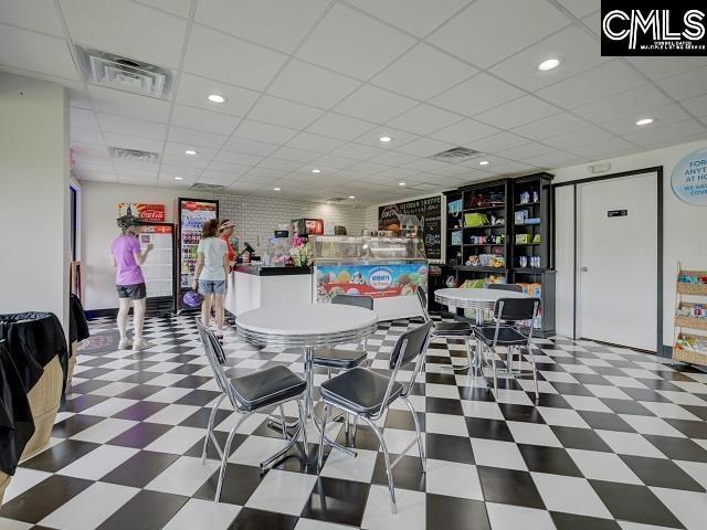 dining space featuring tile patterned floors, a drop ceiling, recessed lighting, and visible vents