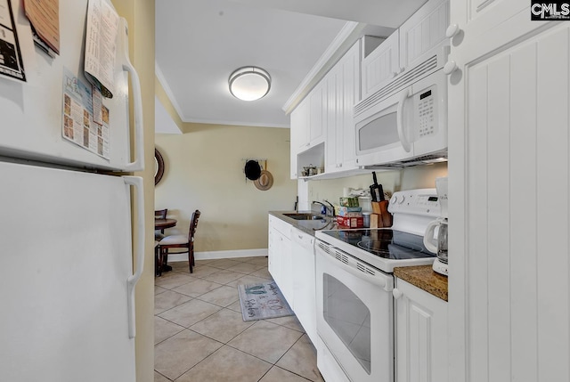 kitchen with a sink, ornamental molding, white appliances, and white cabinets