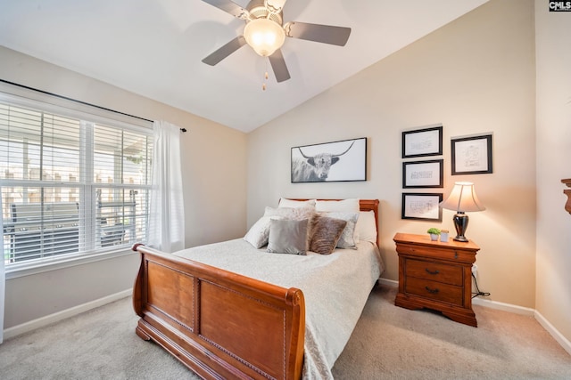 bedroom with baseboards, a ceiling fan, lofted ceiling, and light colored carpet