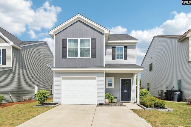 view of front facade featuring a garage, board and batten siding, a front yard, and concrete driveway