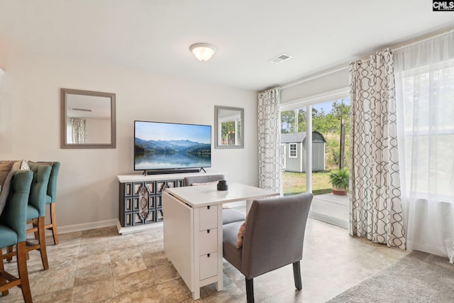 dining space featuring baseboards and visible vents
