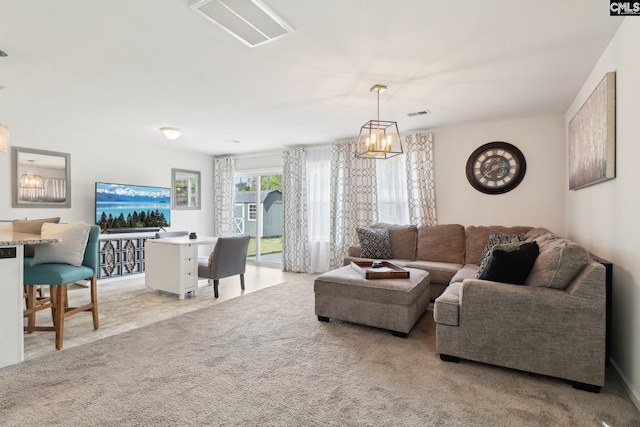 living room featuring an inviting chandelier, light carpet, and visible vents