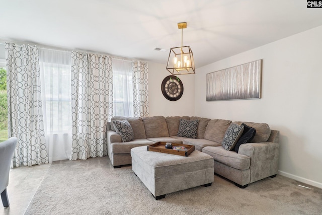 living area featuring an inviting chandelier, baseboards, and visible vents