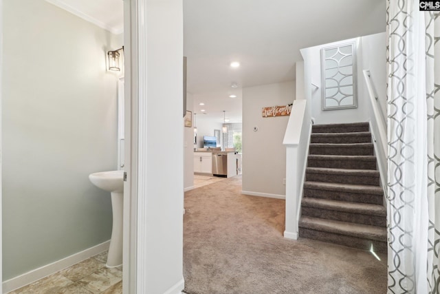 stairs with crown molding, recessed lighting, baseboards, and carpet
