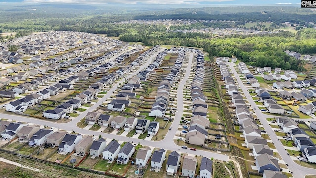 birds eye view of property with a residential view and a forest view