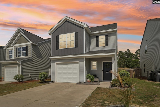 traditional-style home featuring a garage, fence, driveway, and a shingled roof