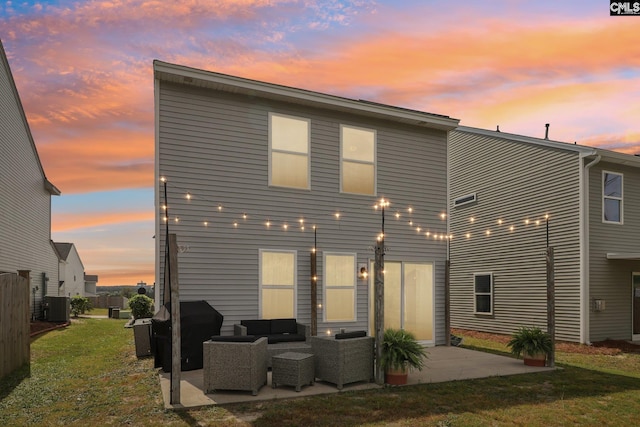 rear view of property with an outdoor living space, a lawn, cooling unit, and a patio area
