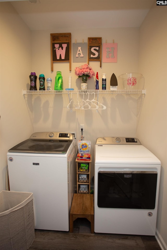 washroom with washing machine and clothes dryer, laundry area, and dark wood-style floors