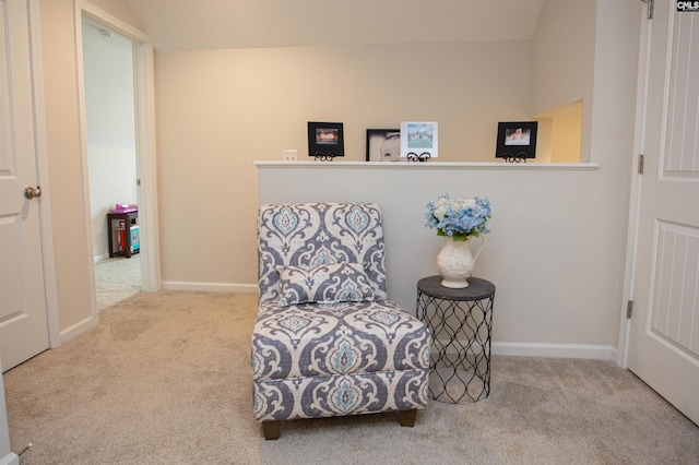 living area featuring baseboards and carpet