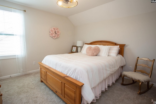 bedroom featuring baseboards, multiple windows, vaulted ceiling, and light colored carpet