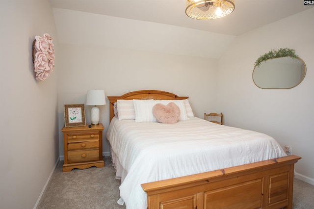 bedroom featuring baseboards, light colored carpet, and lofted ceiling