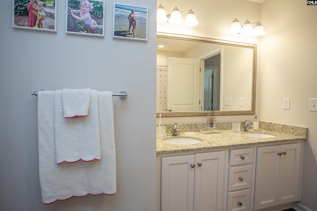 full bath featuring double vanity and a sink