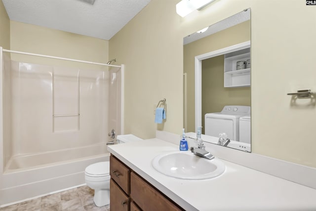 bathroom featuring vanity, bathtub / shower combination, toilet, a textured ceiling, and washing machine and dryer