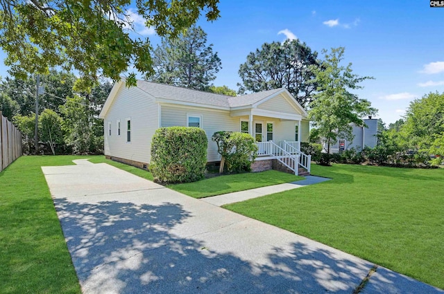 bungalow featuring a porch, crawl space, driveway, a front lawn, and a shingled roof