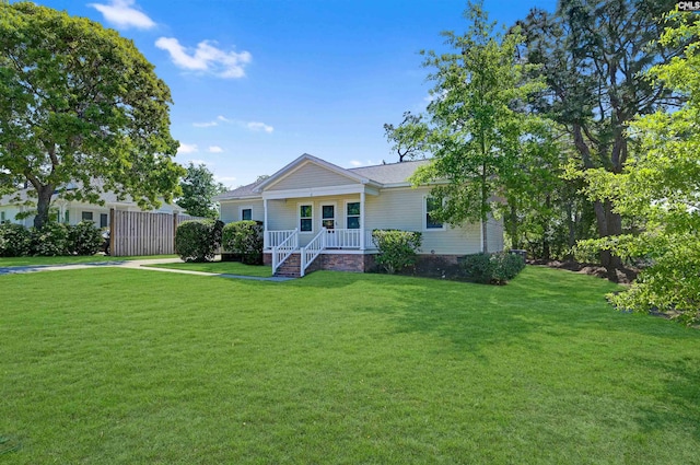 back of property with a porch and a lawn
