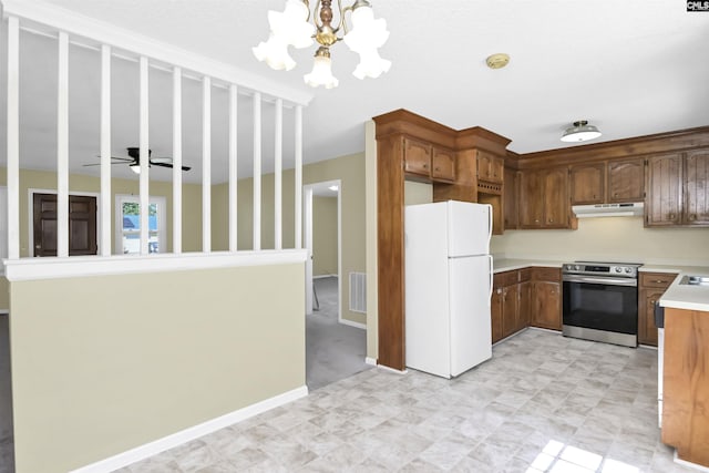 kitchen with electric range, visible vents, light countertops, freestanding refrigerator, and under cabinet range hood