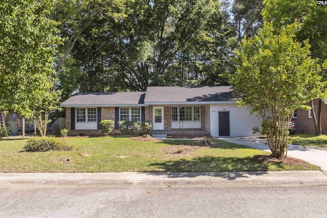 single story home with brick siding and a front yard