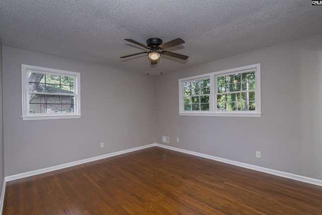 spare room with a ceiling fan, baseboards, and dark wood-type flooring