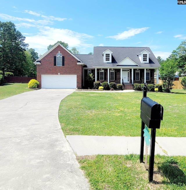 24 Mauser Dr, Lugoff, SC 29078 - cape cod house featuring a front lawn, fence, brick siding, an attached garage, and driveway