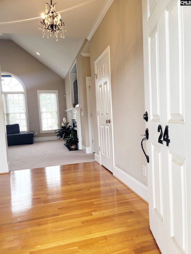 24 Mauser Dr, Lugoff, SC 29078 - entryway featuring a fireplace, a notable chandelier, lofted ceiling, and light wood-style floors