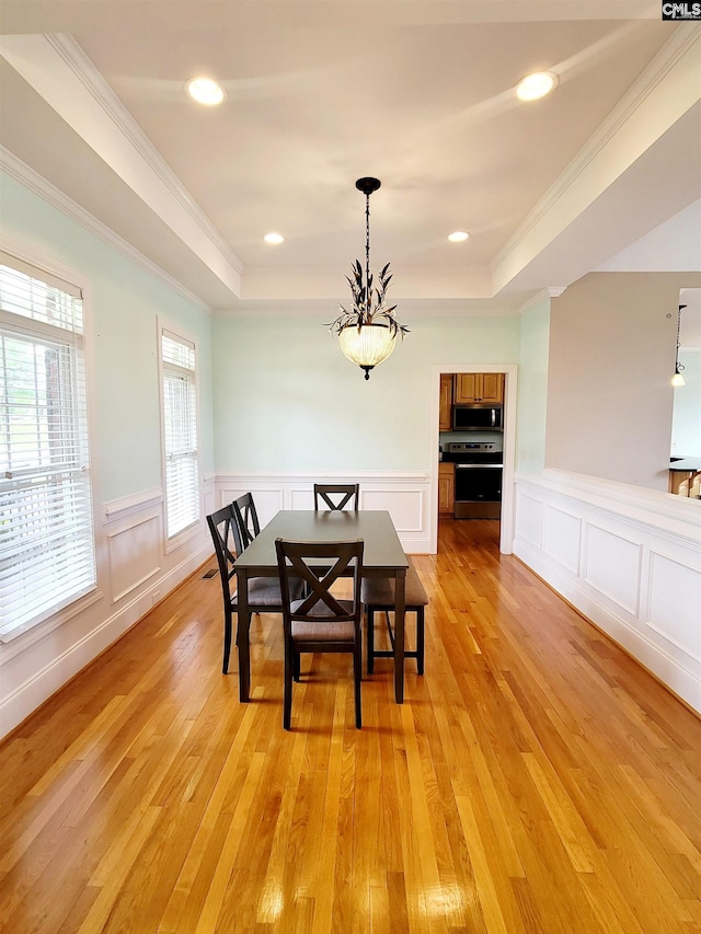 24 Mauser Dr, Lugoff, SC 29078 - dining room with crown molding, a raised ceiling, wainscoting, and light wood-type flooring