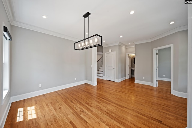 unfurnished dining area featuring an inviting chandelier, recessed lighting, light wood-style floors, and stairway