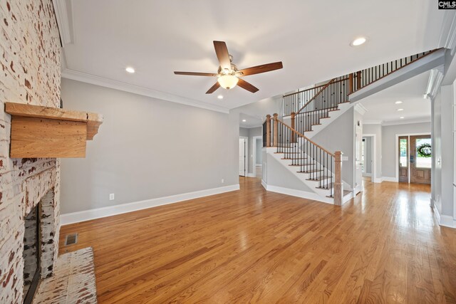 unfurnished living room featuring crown molding, stairs, recessed lighting, a ceiling fan, and light wood-style flooring