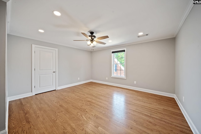 unfurnished room with ceiling fan, ornamental molding, baseboards, and wood finished floors