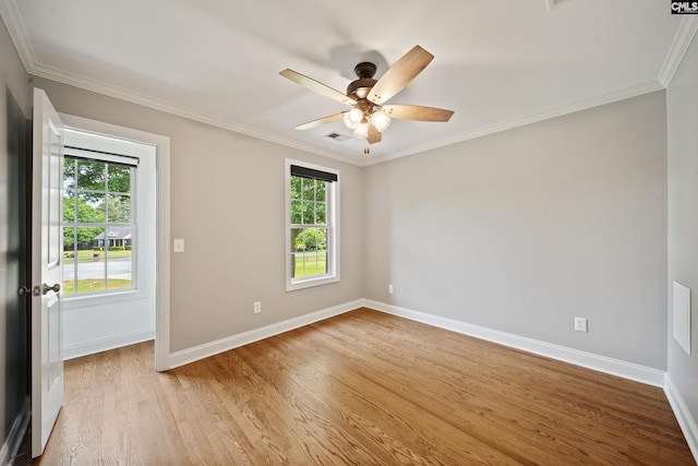 empty room featuring baseboards, a ceiling fan, light wood finished floors, and a wealth of natural light