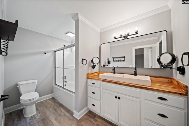 bathroom featuring vanity, ornamental molding, toilet, and wood finished floors